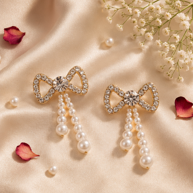 Pair of cascading faux pearl drop earrings with gold-tone crystal bow – bridal and festive jewellery for Indian women