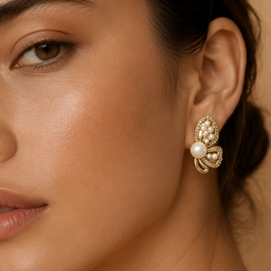 Gold tone CZ butterfly earrings closeup with pearl accents JeevaFashions