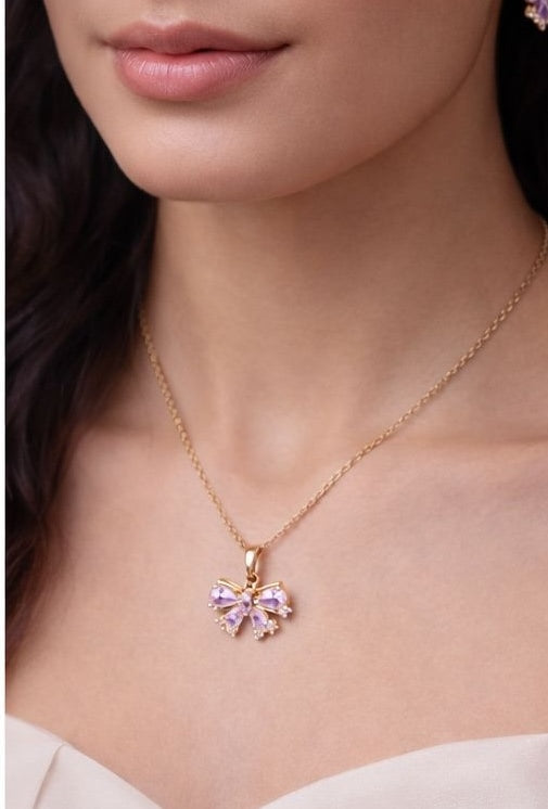 Gold bow necklace and earrings set with pink crystal stones