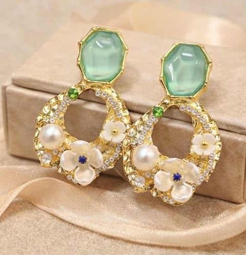 Green stone floral pearl drop earrings styled for Indian women – gold tone party wear earrings for lehenga, saree and festive occasions