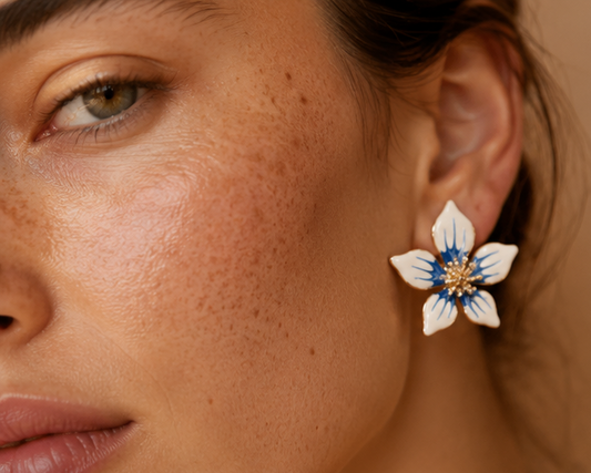 Gold tone orchid earrings closeup with blue detailing JeevaFashions