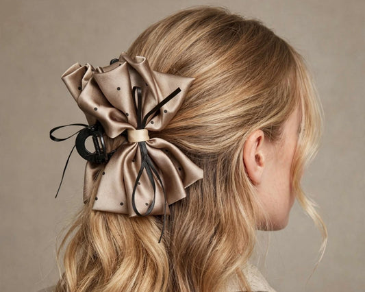 Woman wearing brown-gold satin polka dot bow claw clip in her hair