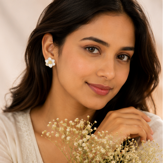 Gold plated white enamel flower earrings closeup for women JeevaFashions