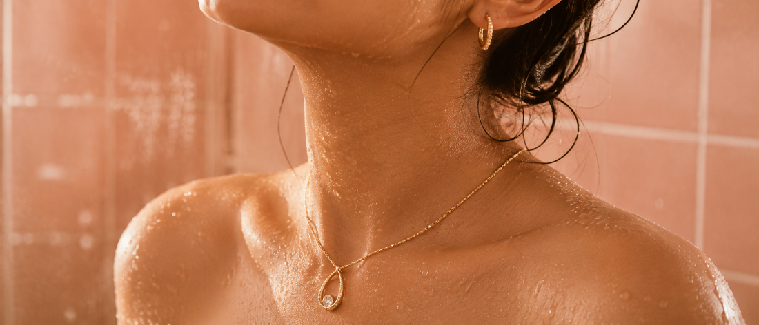 Woman with wet skin wearing anti-tarnish gold plated necklace and earrings, shower safe jewellery