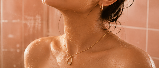 Woman with wet skin wearing anti-tarnish gold plated necklace and earrings, shower safe jewellery