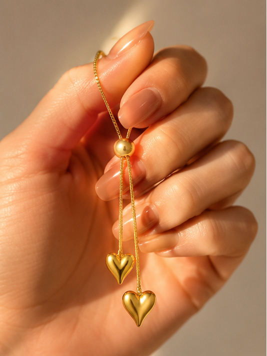 Close-up of 18K gold plated double heart pendant on adjustable lariat necklace – Korean minimalist style