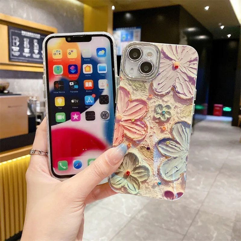Close-up of oil painting floral iPhone case with raised crystal flower accents – luxury aesthetic phone cover