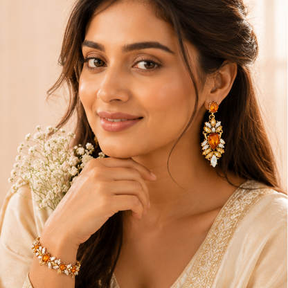 Close-up of iridescent colour-changing crystal drop on amber chandelier earrings – anti-tarnish gold-tone alloy for women