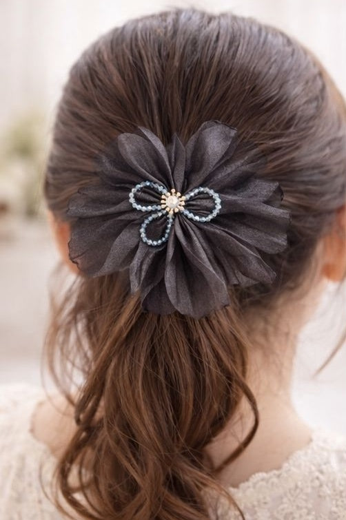 Black floral statement hair clip styled on hair JeevaFashions