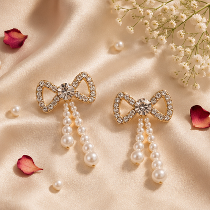 Pair of cascading faux pearl drop earrings with gold-tone crystal bow – bridal and festive jewellery for Indian women