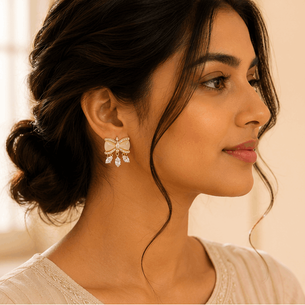 Close-up of crystal bow stud earrings with sparkling rhinestone detailing and crystal dangle drops – party wear earrings for Indian women