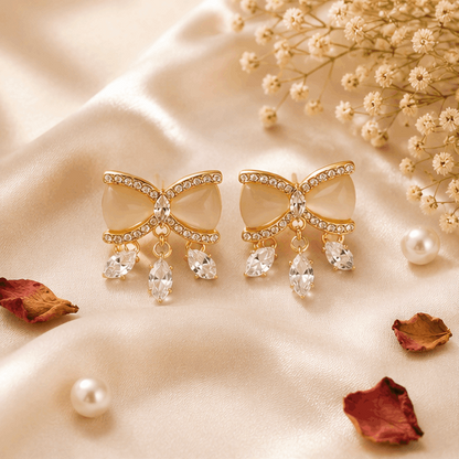 Crystal bow stud earrings styled for festive occasions – rhinestone enamel bow with dangle drops for lehenga and saree styling