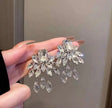 Crystal floral drop earrings in silver transparent finish – dangle party wear earrings for Indian women – weddings, sangeet and festive occasions