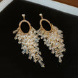 Crystal tassel chandelier earrings in gold tone with rhinestone oval hoop – party wear earrings for Indian women at weddings and festive occasions