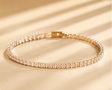 CZ tennis bracelet with rectangle stones in 18K gold plated stainless steel – flat lay on white background for women