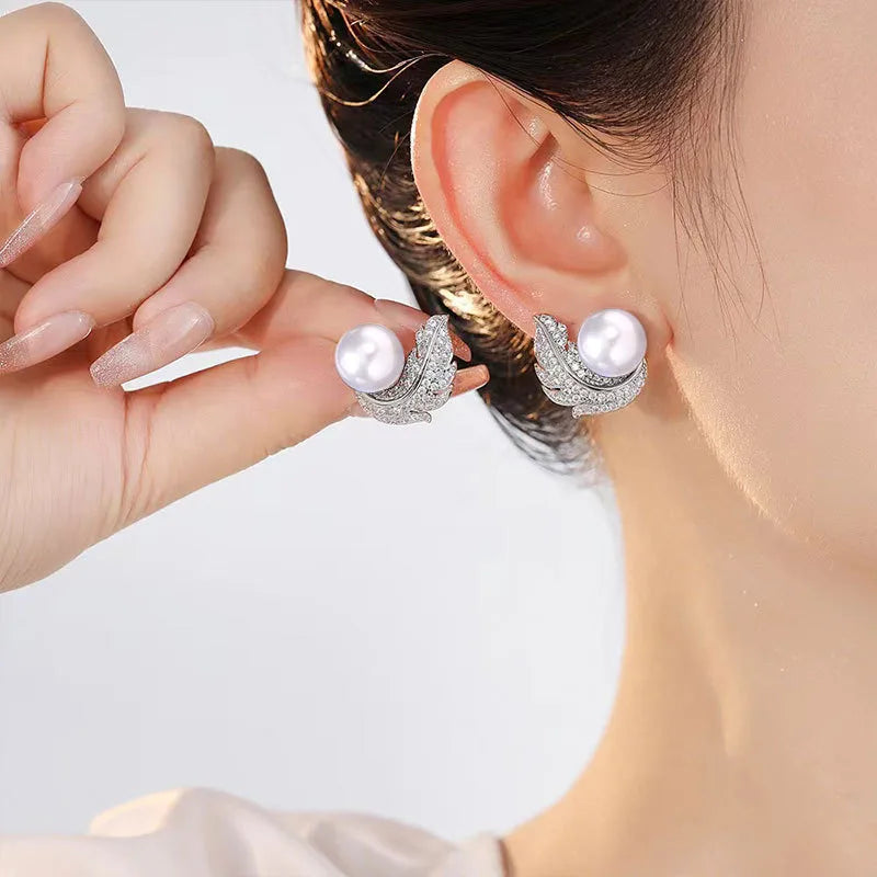 Close-up of feather pearl stud earrings with sparkling rhinestone inlay – anti-tarnish 925 silver-toned earrings for women