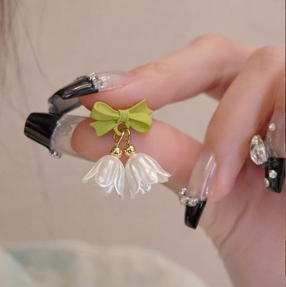 Floral drop earrings with green bow accent close up JeevaFashions