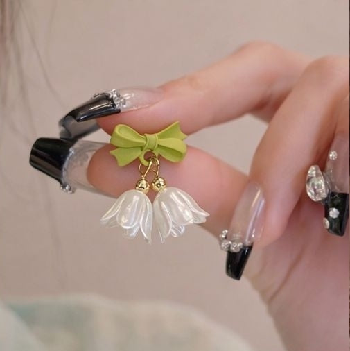 Floral drop earrings with green bow accent close up JeevaFashions