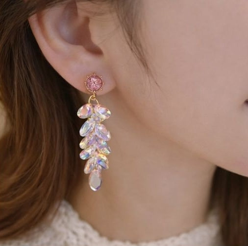 Close-up of iridescent glass crystal waterdrop tassel earrings in gold tone – geometric cascade design for Indian festive occasions