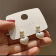 Glossy heart pearl charm earrings close up JeevaFashions