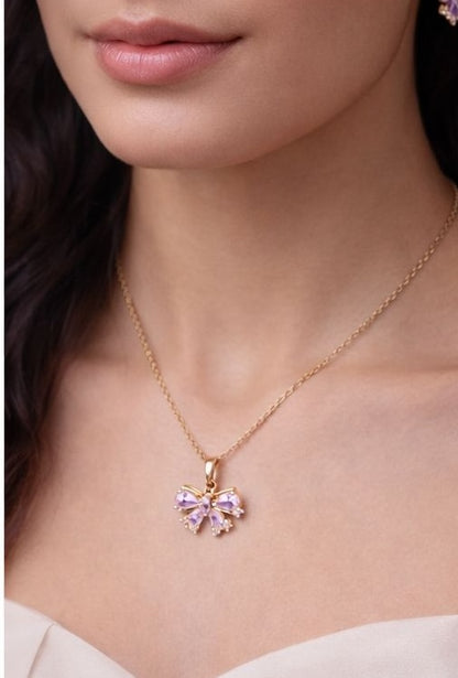 Gold bow necklace and earrings set with pink crystal stones