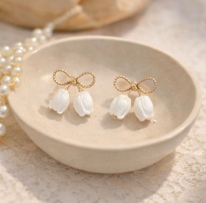 Gold bow stud earrings with pearl petal charms styled for daily wear – gifting and everyday jewellery for women