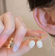 Gold bow stud earrings with white pearl petal charms for women – lightweight anti-tarnish daily wear earrings