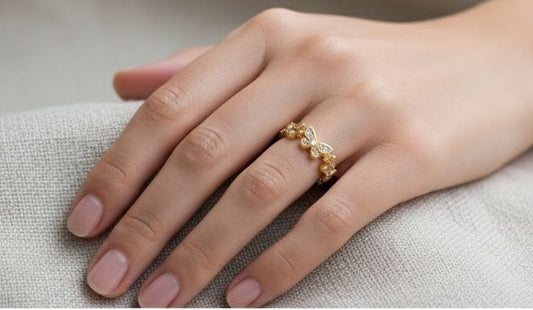 Adjustable gold butterfly ring on finger lifestyle shot