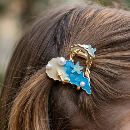Side view of gold hair claw clip with blue enamel and shell charm for women at JeevaFashions