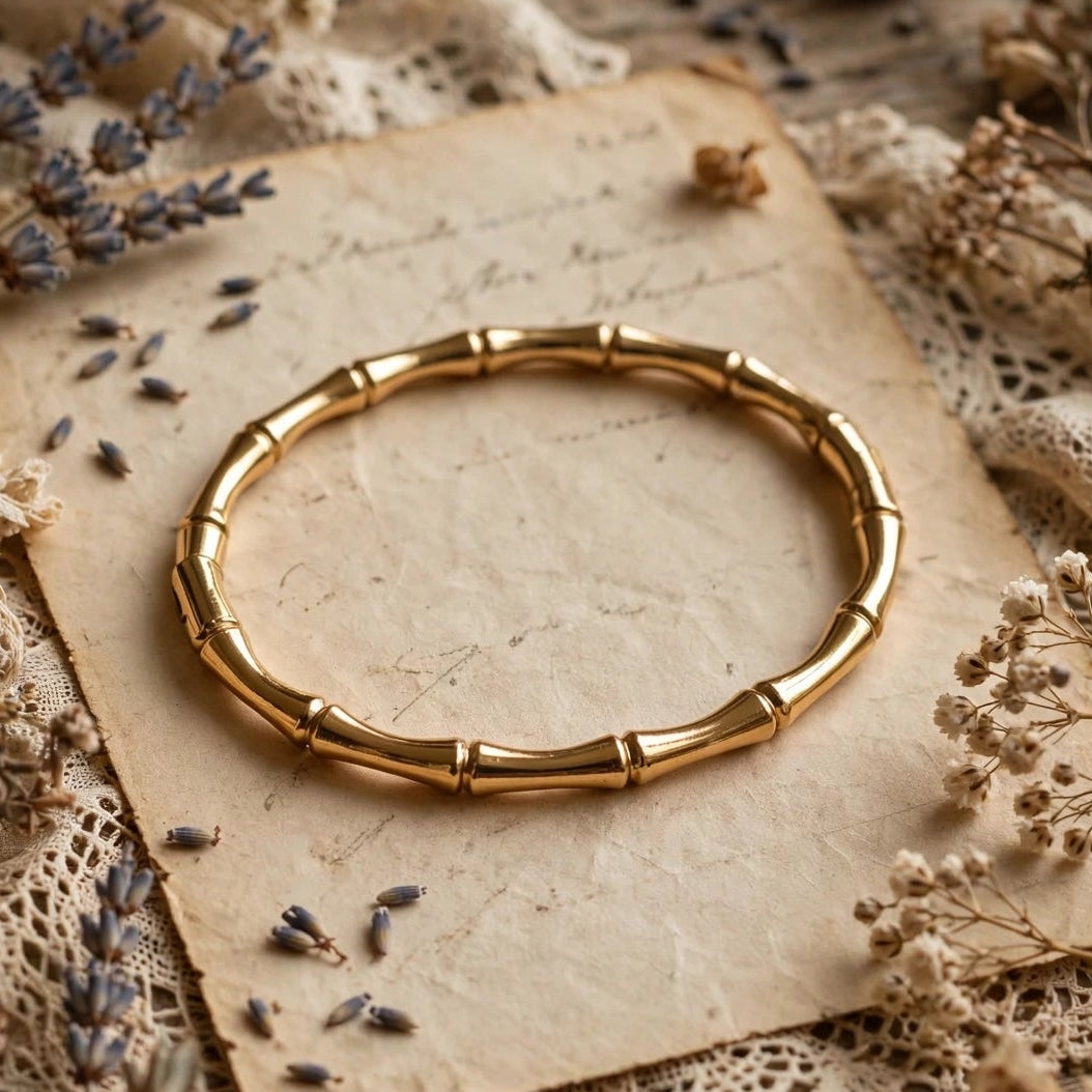 Gold open cuff bamboo bangle bracelet on satin background for women at JeevaFashions