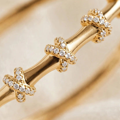 Side angle of pave X knot bangle bracelet in 316L stainless steel for women at JeevaFashions