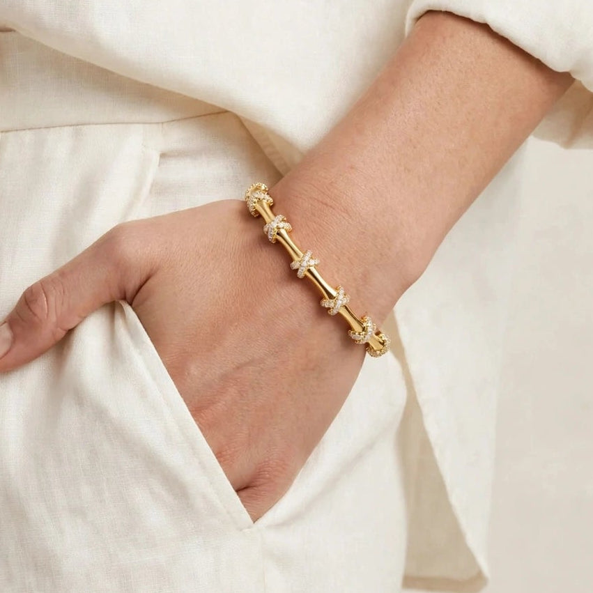 Pave X knot bangle bracelet styled on wrist for women at JeevaFashions