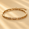 Flat lay of gold plated bamboo bracelet with glass stone accents – festive jewellery gift for women