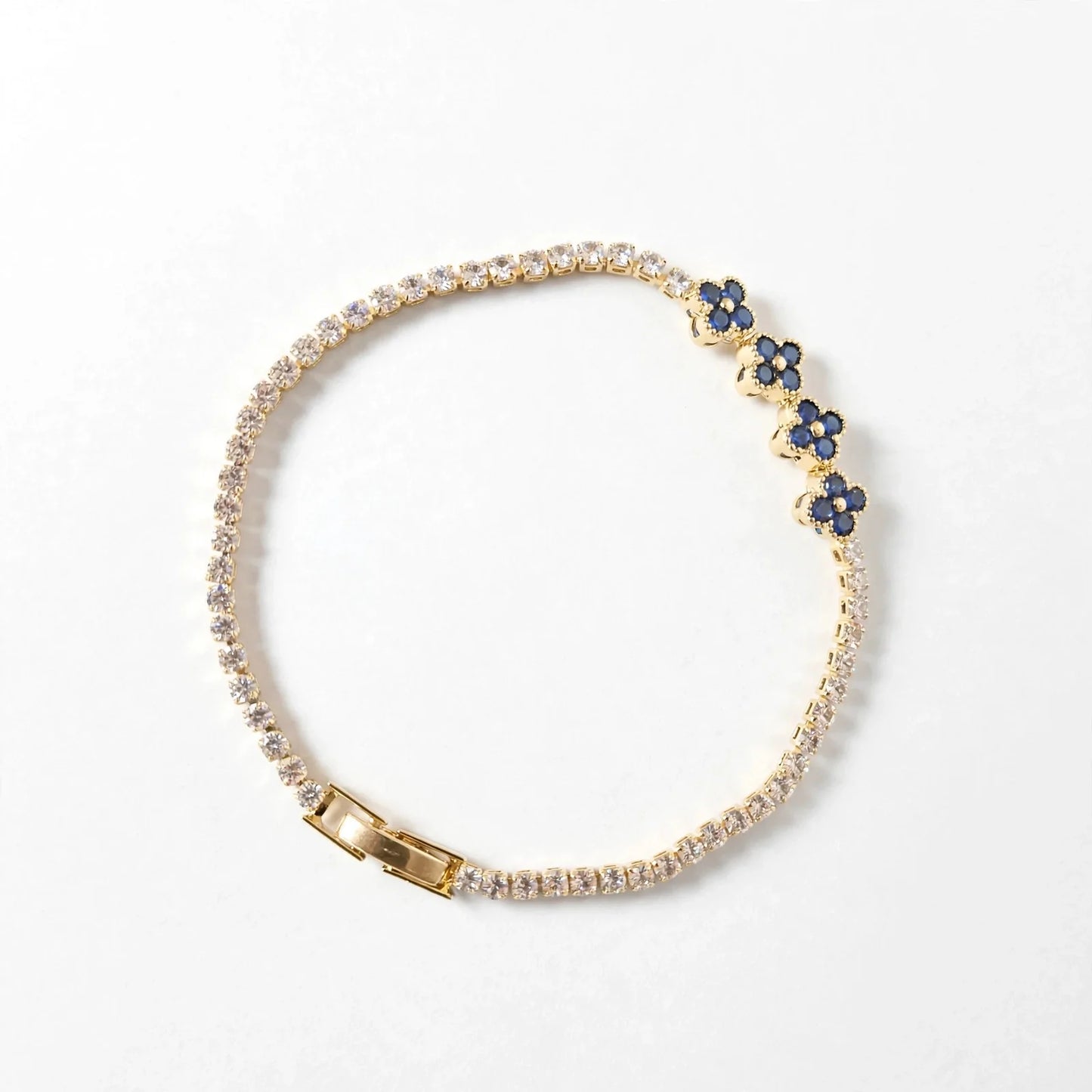 Blue clover CZ tennis bracelet gold plated flat lay for women JeevaFashions