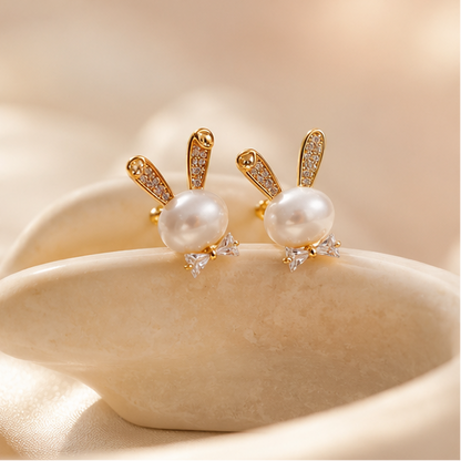 Gold plated faux pearl bunny stud earrings with crystal bow accent – styled product shot for Diwali and wedding occasions