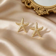 Gold plated starfish stud earrings closeup – anti-tarnish beach travel jewellery for women by JeevaFashions
