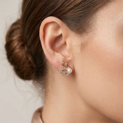 Gold plated swan earrings side view JeevaFashions