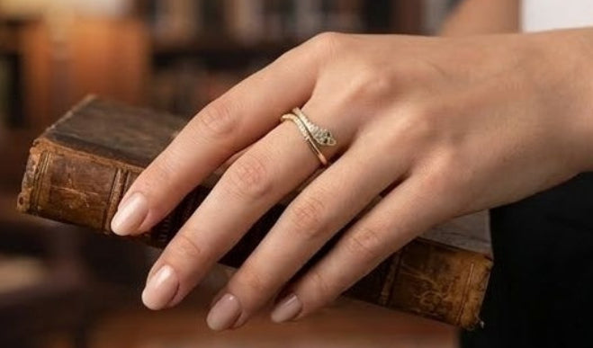 Adjustable gold serpent wrap ring with CZ crystals on finger