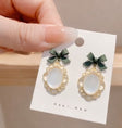 Gold-tone oval cat eye bow earrings for women – glamorous date night and going-out jewellery