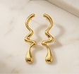 Trendy gold wavy earrings Korean style minimal statement JeevaFashions