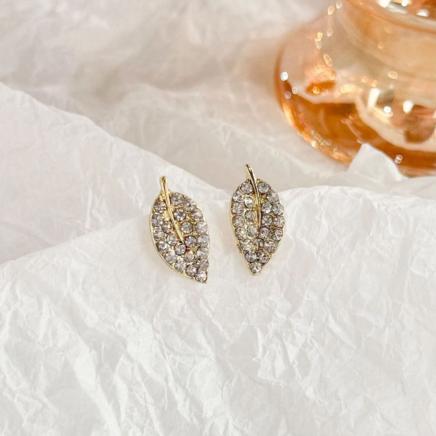 Golden glister pave leaf stud earrings for women JeevaFashions