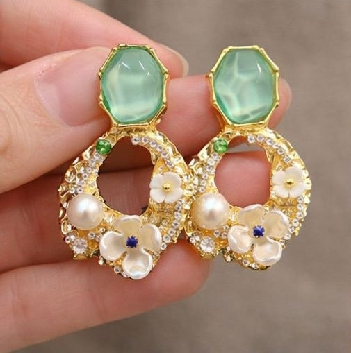Close-up of green stone floral pearl drop earrings – gold-tone floral setting with pearl embellishments for Indian festive occasions
