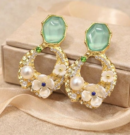 Green stone floral pearl drop earrings styled for Indian women – gold tone party wear earrings for lehenga, saree and festive occasions