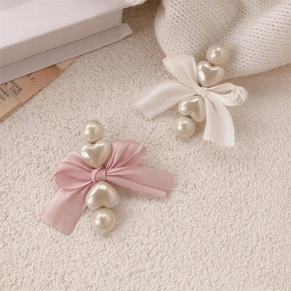 Heart duckbill clip with pearl bow styled on hair JeevaFashions