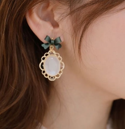 Oval cat eye stone bow earrings in gold-tone alloy – trendy going-out earrings for Indian women