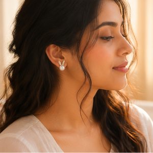 Close-up of mismatched pearl bunny stud earrings showing micro-crystal and white enamel ear detail – JeevaFashions