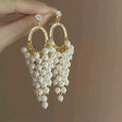 Pearl hoop earrings with cascading cluster drop in gold tone – elegant party wear earrings for Indian women – weddings and festive occasions