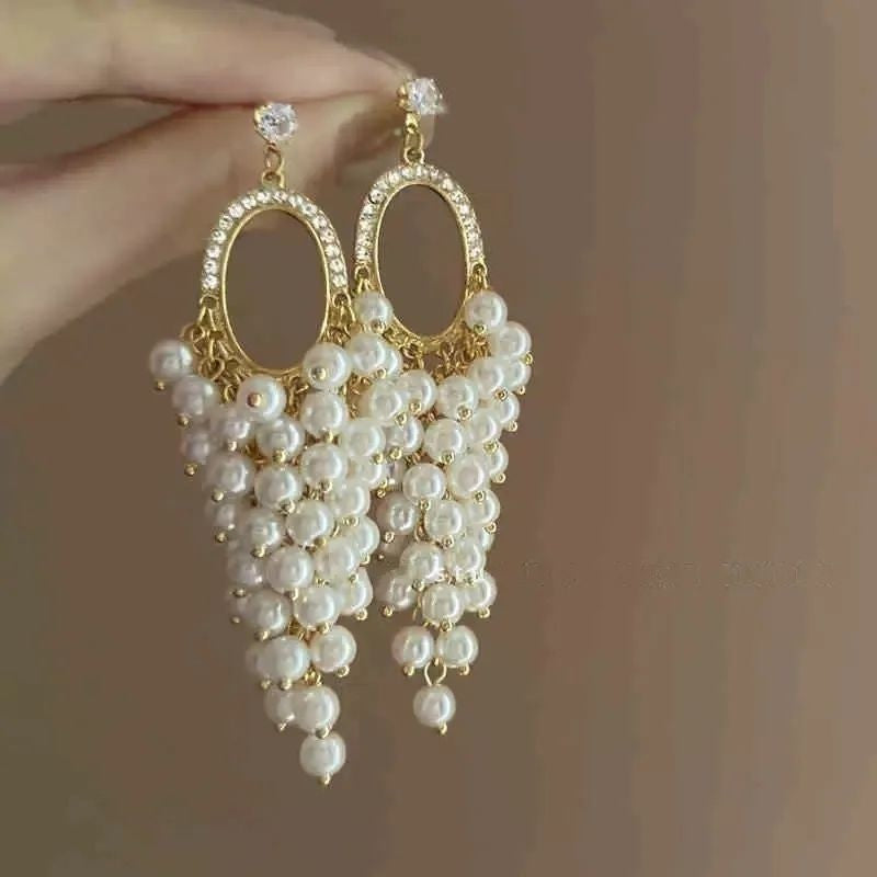 Pearl hoop earrings with cascading cluster drop in gold tone – elegant party wear earrings for Indian women – weddings and festive occasions