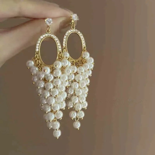 Pearl hoop earrings with cascading cluster drop in gold tone – elegant party wear earrings for Indian women – weddings and festive occasions