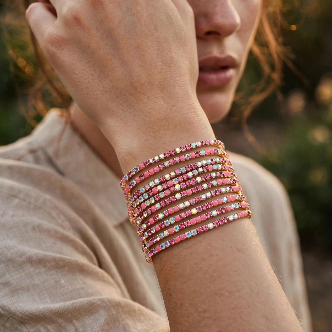 Side angle of pink crystal chain bangle in gold plating for women at JeevaFashions